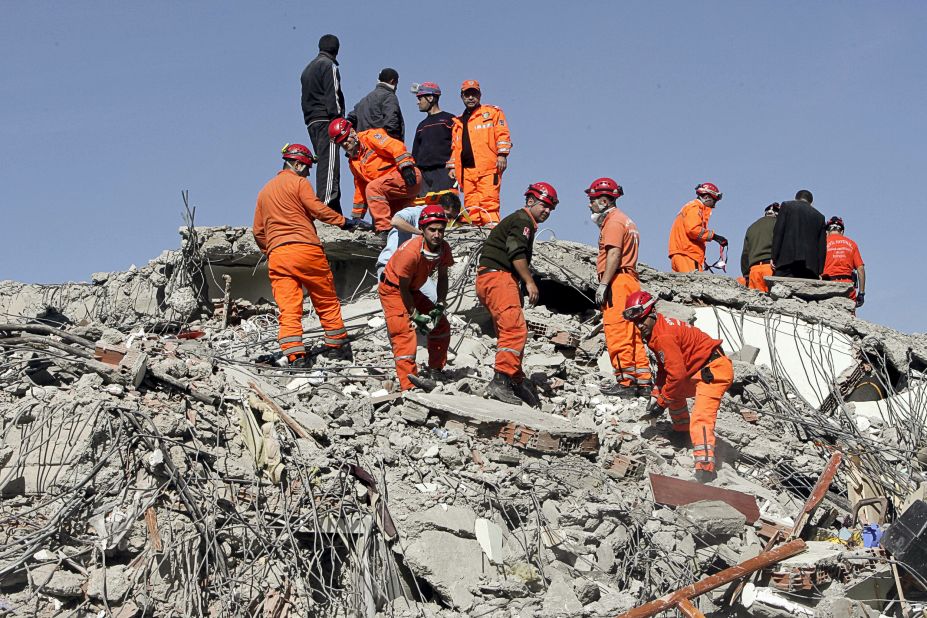Turkish rescuers try to find survivors in the rubble of a collapsed building in Van on Monday.