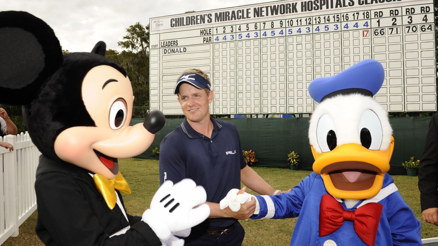 Luke Donald is congratulated by Mickey Mouse and Donald Duck after his decisive victory at the Walt Disney World Resort tournament on Sunday.