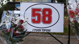 Flowers are laid under a sign displaying Simoncelli's racing number of 58 in his hometown of Cattolica.