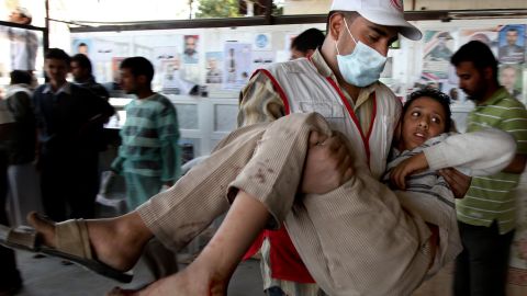 A wounded Yemeni protester is carried by a Red Crescent medic to a makeshift hospital near Sanaa's Change Square. 