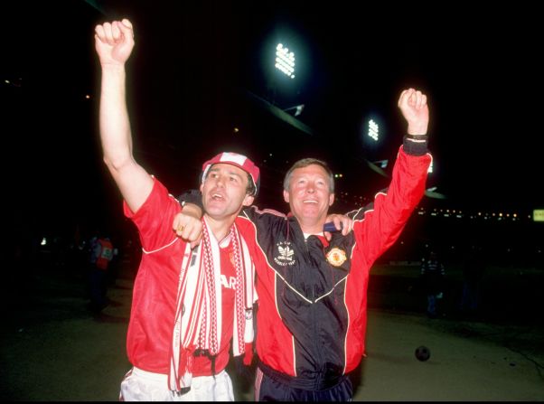 Ferguson survived a difficult first four years at Manchester United before winning a title -- the 1990 FA Cup. Here he celebrates with Bryan Robson, who became the first United captain to lift the trophy three times after beating Crystal Palace 1-0 in the final replay. 