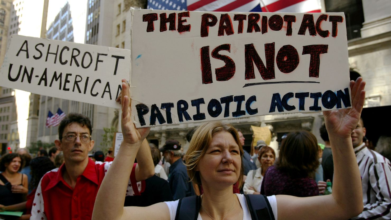Protesters hold up signs criticizing the Patriot Act and then-U.S. Attorney General John Ashcroft on September 9, 2003 .