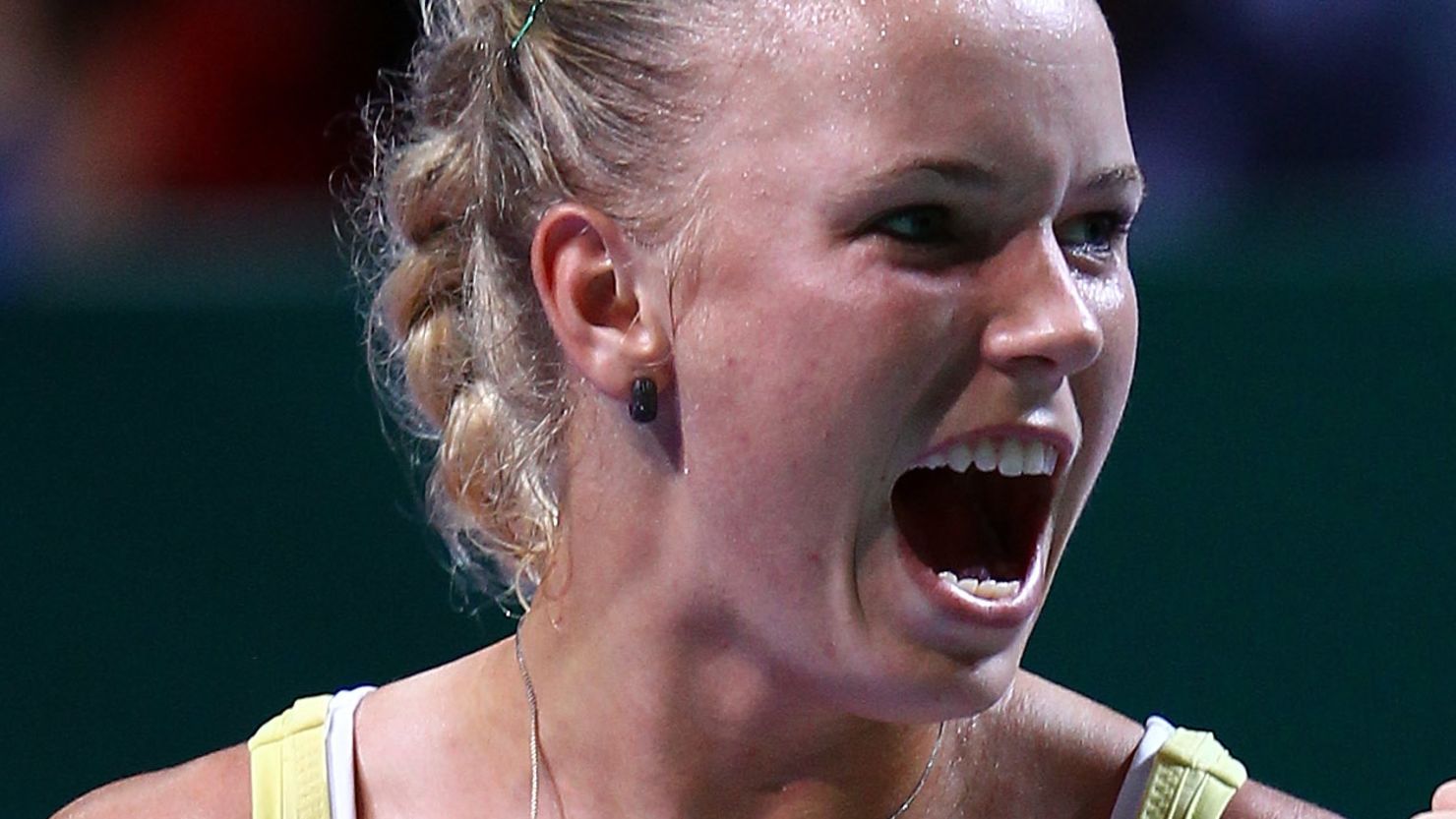 A pumped up Caroline Wozniacki enjoys her moment of truimph against Agnieszka Radwanska  