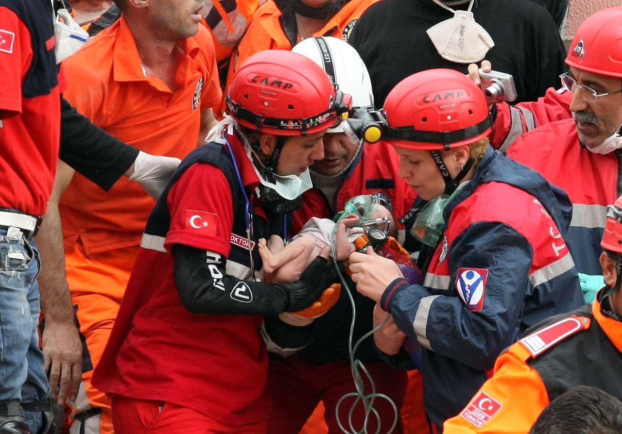Rescue workers carry 2-week-old baby Azra Karaduman. The baby was pulled from debris on Tuesday, October 25, in Ercis, Turkey, two days after a deadly earthquake devastated parts of eastern Turkey.