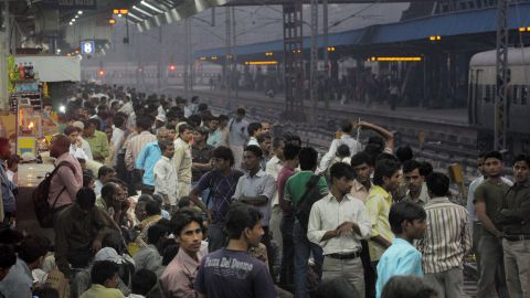 Commuters crowd a platform at a train station in downtown New Delhi, one of the world's most populous cities, on October 25.