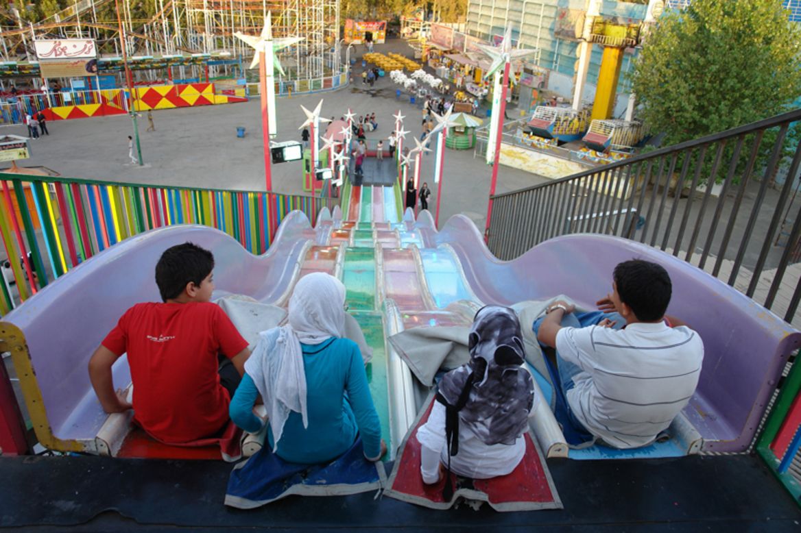A family prepares to tackle the slides at Eram Park. 