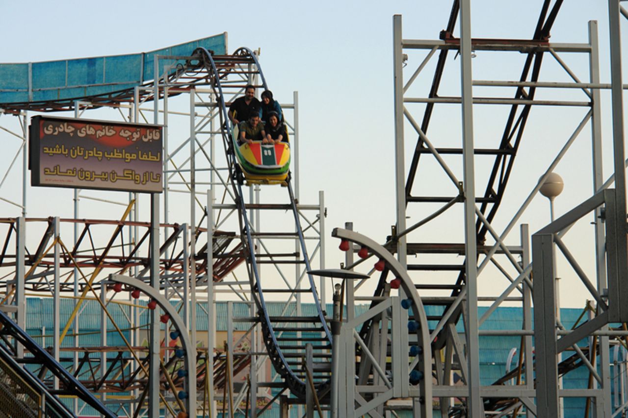 Riders take the first plunge on one of Eram Park's "rusting" roller coasters.
