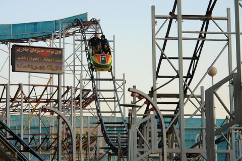 Riders take the first plunge on one of Eram Park's "rusting" roller coasters.