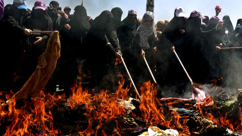 Yemeni veiled women burn veils in a symbolic and traditional move in Sanaa on October 26, 2011 to protest the regime's crackdown on female protesters.