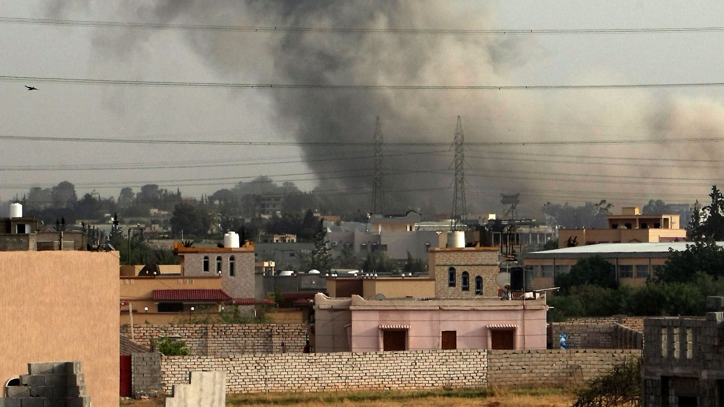 Smoke billows from a suburb of Tripoli on June 4, after NATO warplanes launched intensive air raids the capital.