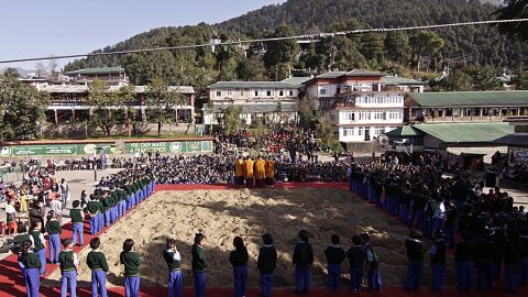 Tibetan exiles gather around soil from their native country that has been transported to India.