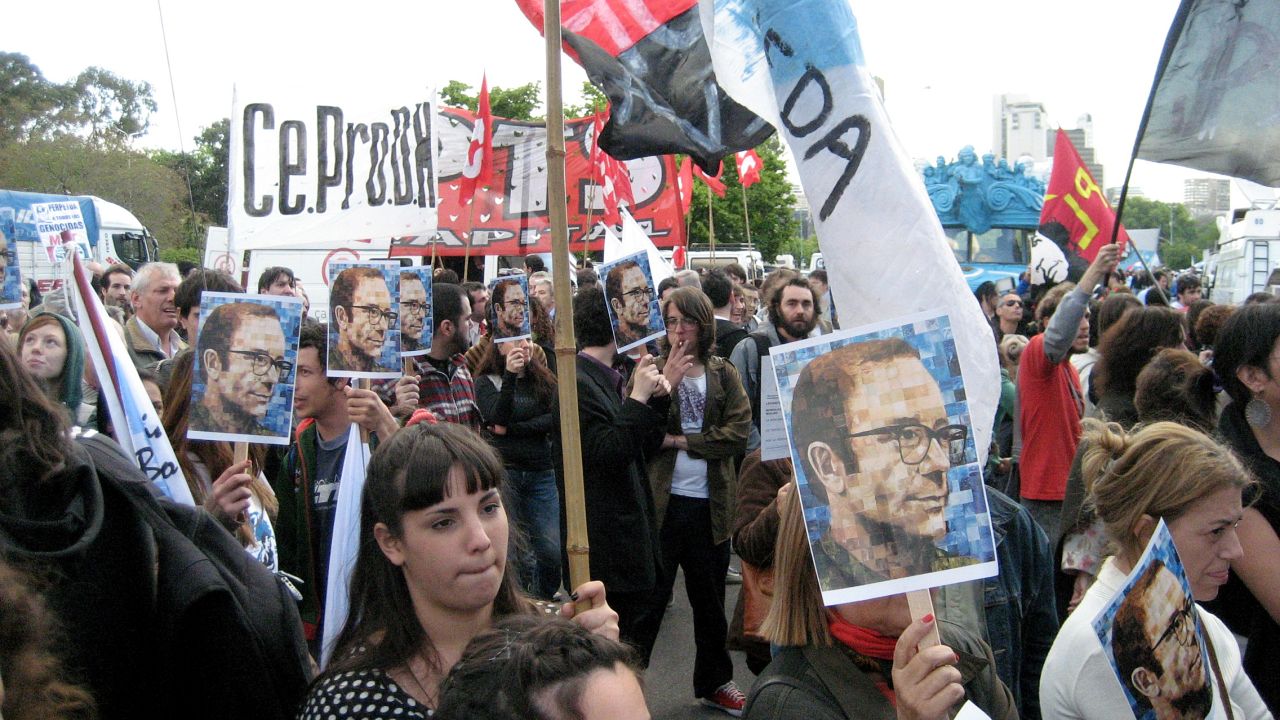 Demonstrators gather outside the Argentina courthouse where 16 former military officers were found guilty.