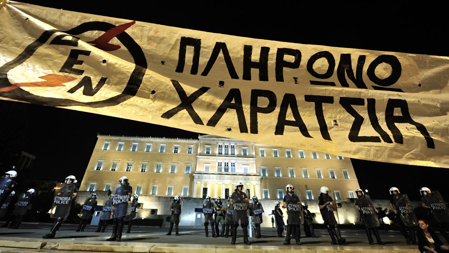 Demonstrators hold a huge banner that reads 'I wont pay the head-tax' in front of the Greek parliament on September 25. 