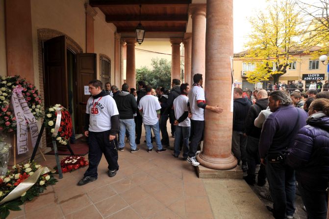 Motorsport fans gather outside the theater in the Italian town. The 24-year-old MotoGP rider died following a crash in Malaysia on Sunday.