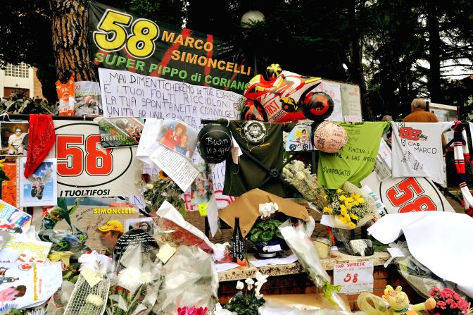 Mourners lay flowers in Marco Simoncelli's hometown of Coriano as a sign of their respect for the former Honda rider.