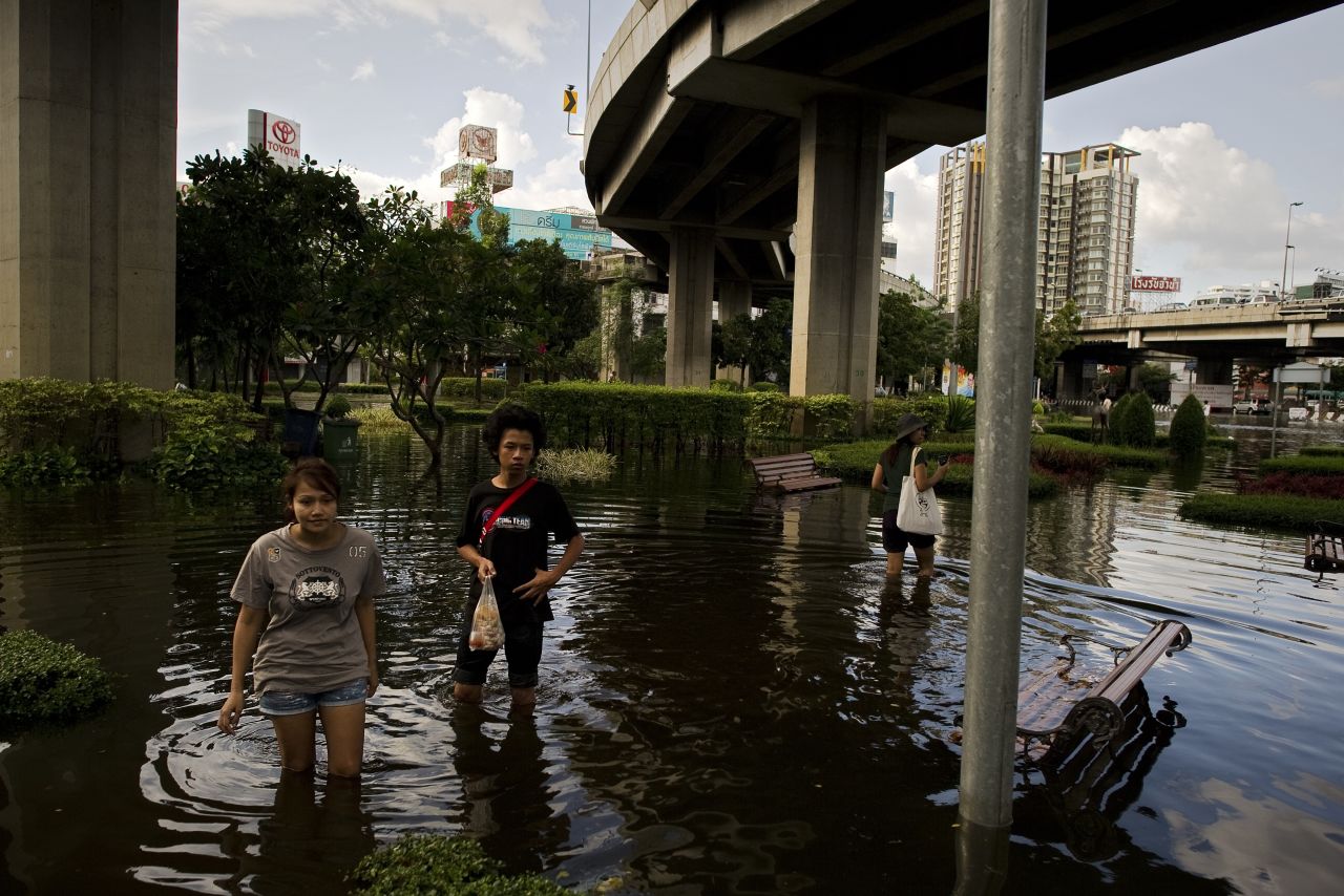 Residents wait for a rescue boat as they evacuate their neighborhood next to the Chao Praya River in Bangkok on Friday. 