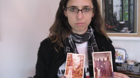 Marianela Galli, 35, holds photographs of family members who were tortured and killed during Argentina's "Dirty War."