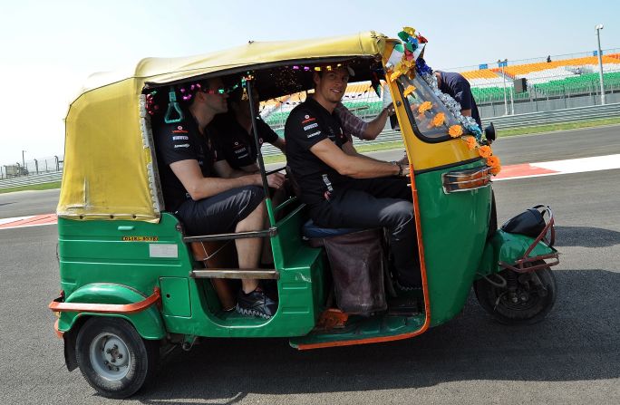 McLaren's former world champion driver Jenson Button hitches a ride in an autorickshaw as he inspects the track on Thursday.