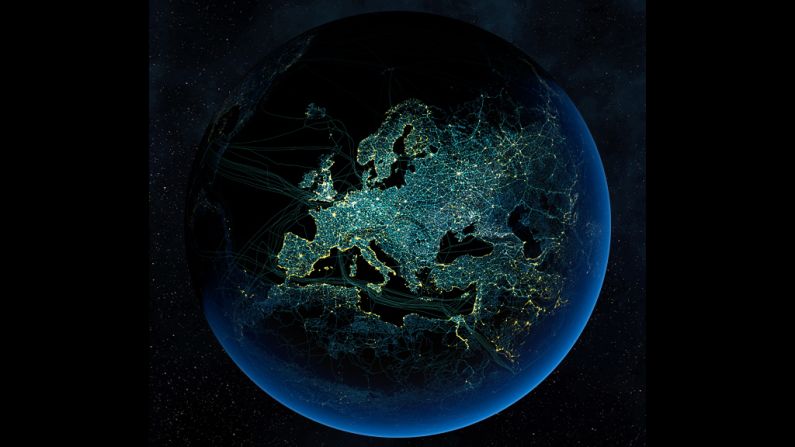 Major road and rail networks in Europe, along with transmission lines and underwater cables are superimposed above the continent's cities illuminated at night. 