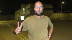 Saif al-Islam Kadhafi, son of Libyan leader Moamer Kadhafi, flashes the V-sign for victory as he appears in front of journalists at his father's residential complex in the Libyan capital Tripoli in the early hours of August 23, 2011.