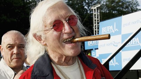 Veteran British radio DJ and TV presenter Jimmy Savile cut a distinctive figure, with cigar, tracksuit and chunky jewelry.