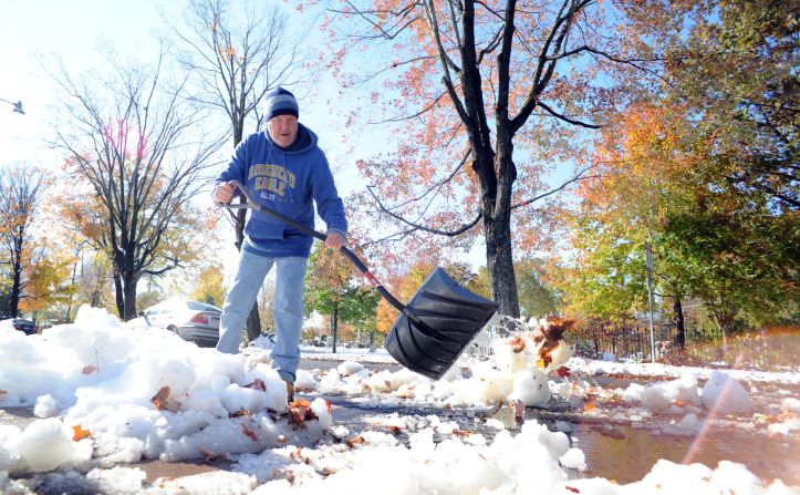 Jim Nisula of Doylestown, Pennsylvania, shovels snow outside his home on Sunday, October 30. More than 4 million people lost power in their homes due to the storm.
