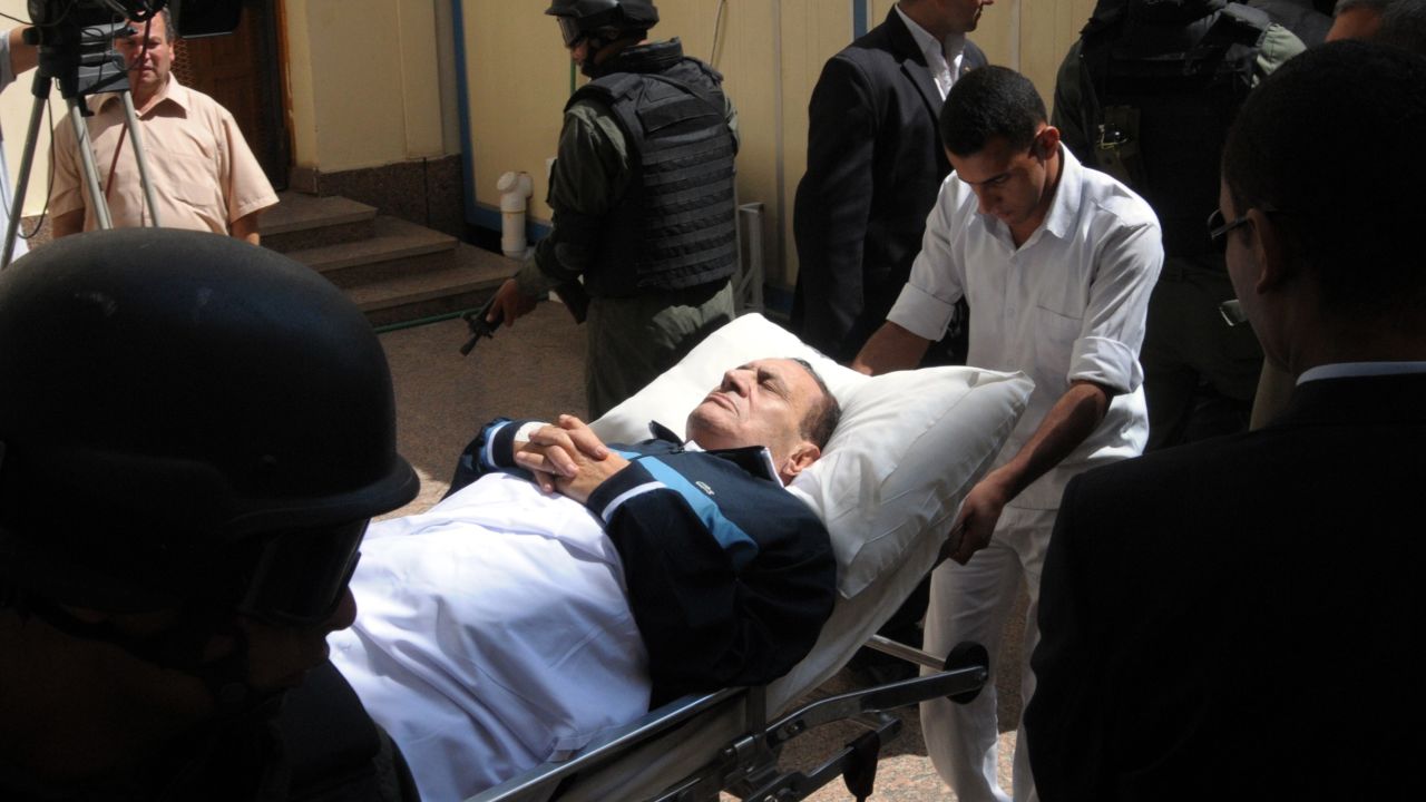 Ousted Egyptian president Hosni Mubarak lies on a stretcher as he is wheeled into a courtroom in Cairo on September 7, 2011.