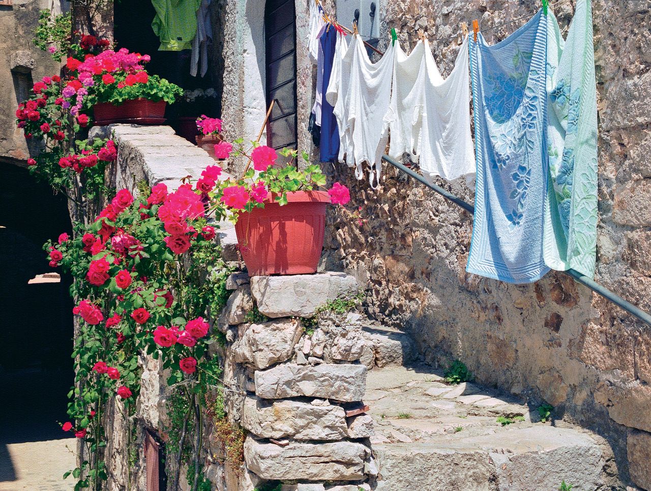 Geraniums add color to the village's 1,000-year old stone walls.