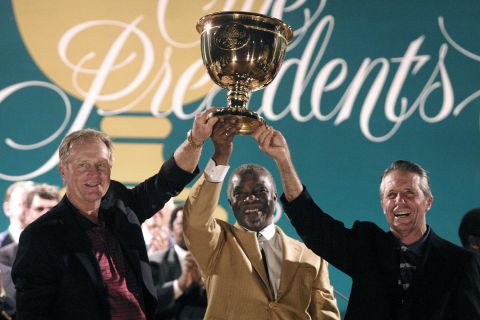 South Africa's then President Thabo Mbeki holds aloft the Presidents Cup with 2003 team captains Jack Nicklaus and Gary Player.