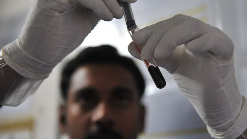 A healthcare worker collects a blood sample from a man at a mobile Integrated counselling and testing centre (ICTC) in Hyderabad on November 26, 2010.