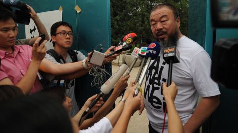 Chinese artist  Ai Weiwei speaks to reporters outside his studio in Beijing in June earlier this year. 