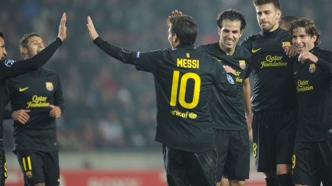 Barcelona's Lionel Messi celebrates with his teammates after scoring his third goal in Prague on Tuesday.