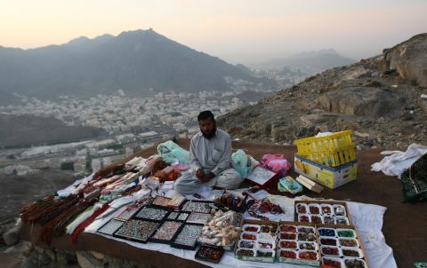 A man sells gifts to Muslim pilgrims on their way up Noor Mountain,  Mecca, during the Hajj 2009. The Green Pilgrimage Network, says pilgrim cities need to address the culture of consumerism to become more sustainable. 