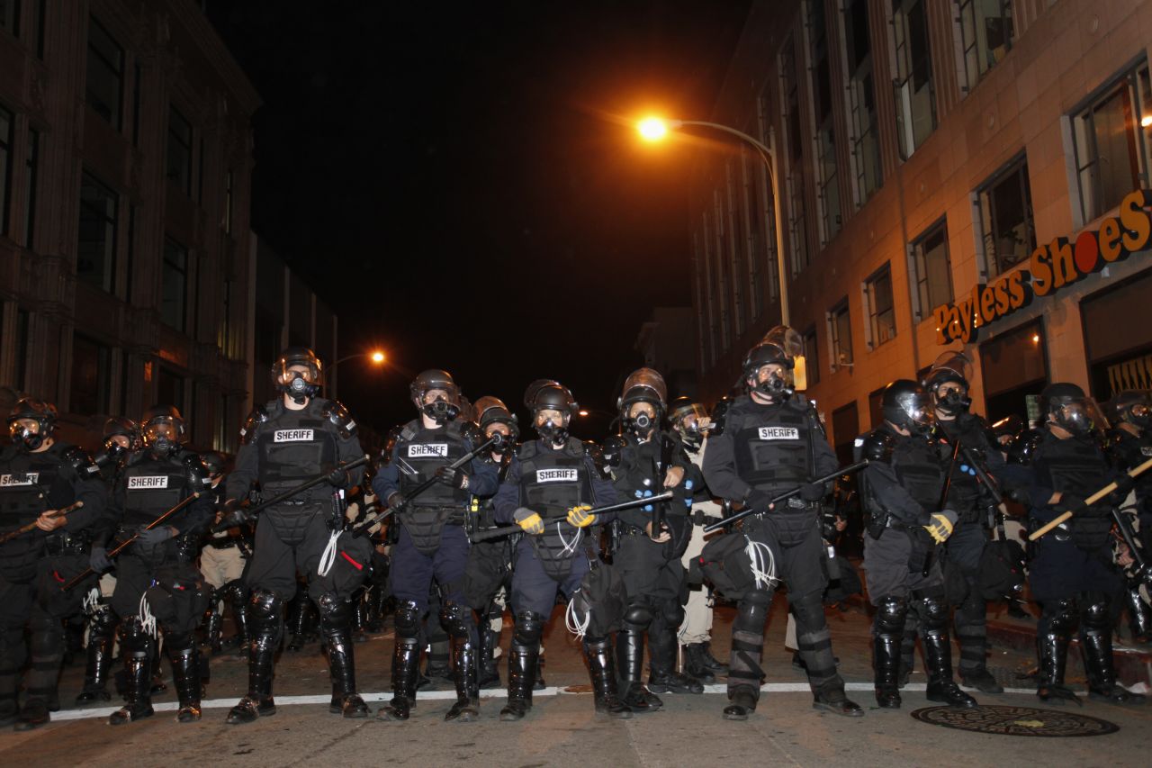 Oakland, California, police form a line to disperse protesters who barricaded themselves on a street near Oakland City Hall early Thursday, November 3. Police say they fired tear gas at demonstrators after a crowd threw rocks and shot fireworks at officers.