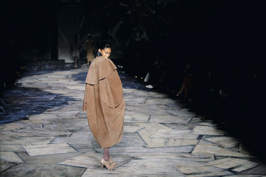 A model walks the catwalk wrapped in a coat from the Black Coffee fashion range.