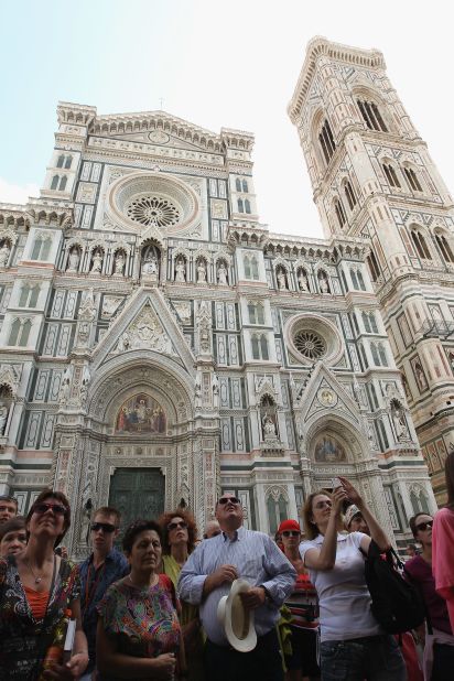 The Duomo is situated in the Piazza del Duomo. The facade of the Duomo is covered in pieces of pink, white and green marble. To the right of the picture is Giotto's Campanile, or belltower, a fine example of Renaissance design, which houses seven bells. 