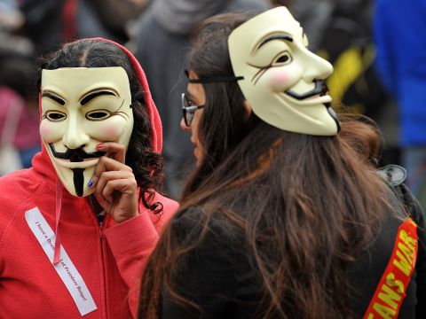 Protesters wearing Guy Fawkes masks gather outside St. Paul's Cathedral in London on October 16.