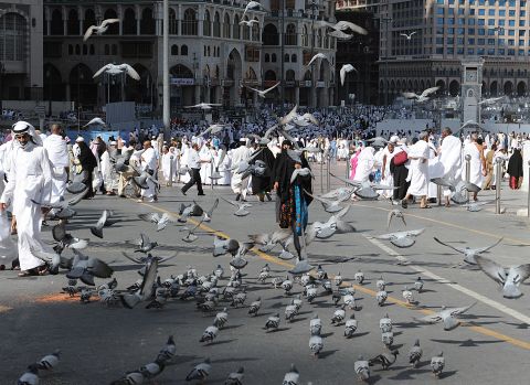 Pigeons fly over pilgrims near the Grand Mosque in the Saudi holy city of Mecca on Thursday. The event draws roughly 2.5 million pilgrims each year.