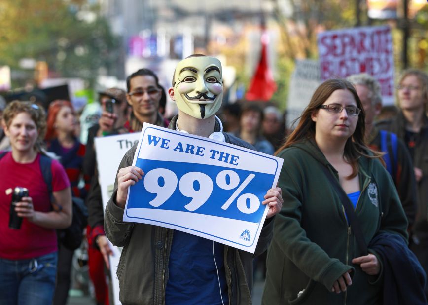 Another masked protester marches during Occupy Vancouver on October 15.