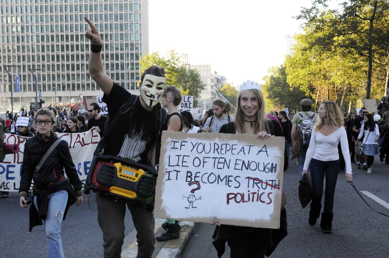 Another masked protester joins 6,000 people marching in Brussels, Belgium on October 15.