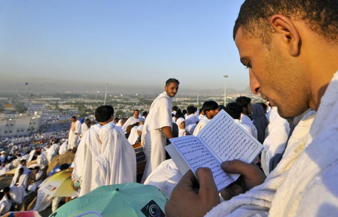 Pilgrims read from the Quran atop Mount Arafat on Saturday in Mecca.