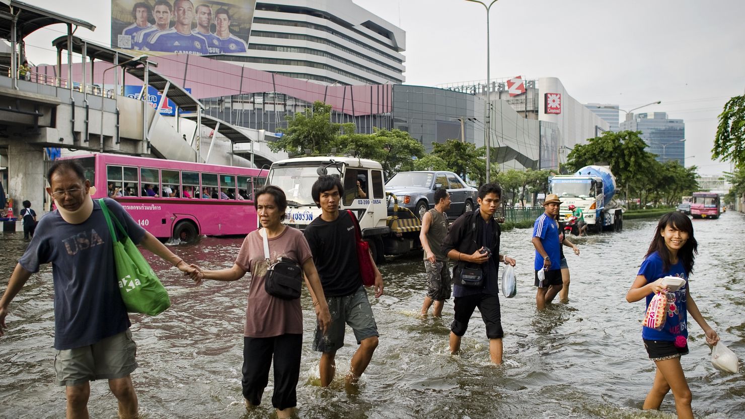 People walk through the flooded streets in Lat Phrao shopping and business district in Bangkok, Thailand, on November 5, 2011.