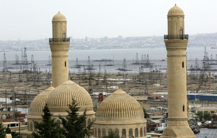 Oil derricks are glimpsed through the minarets of a mosque in Baku. Azerbaijan has vast oil reserves and at one point in the early 20th century was producing half of the world's oil output. 