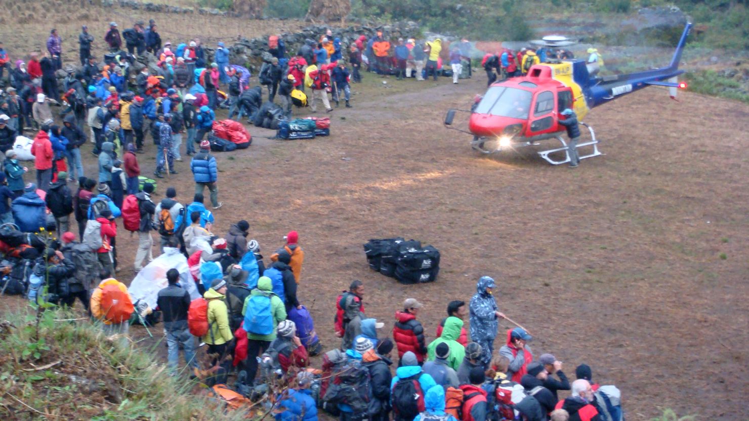 Tourists wait to be rescued by private helicopter from the village of Surke near Lukla, on November 5 2011.