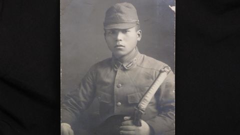 Takeo Oka served in the Japanese Imperial Navy. He's shown in uniform holding samurai sword.