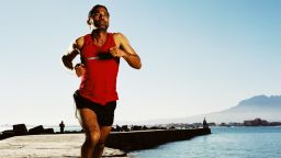 Latino man jogging running water