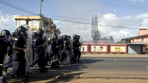 Liberian riot police surge a main thoroughfare during a rally in Monrovia on Monday.