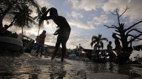 Haitians wash clothes in a stream in Port-au-Prince in January. The widespread user of rivers has been liked to the country's deadly cholera outbreak.