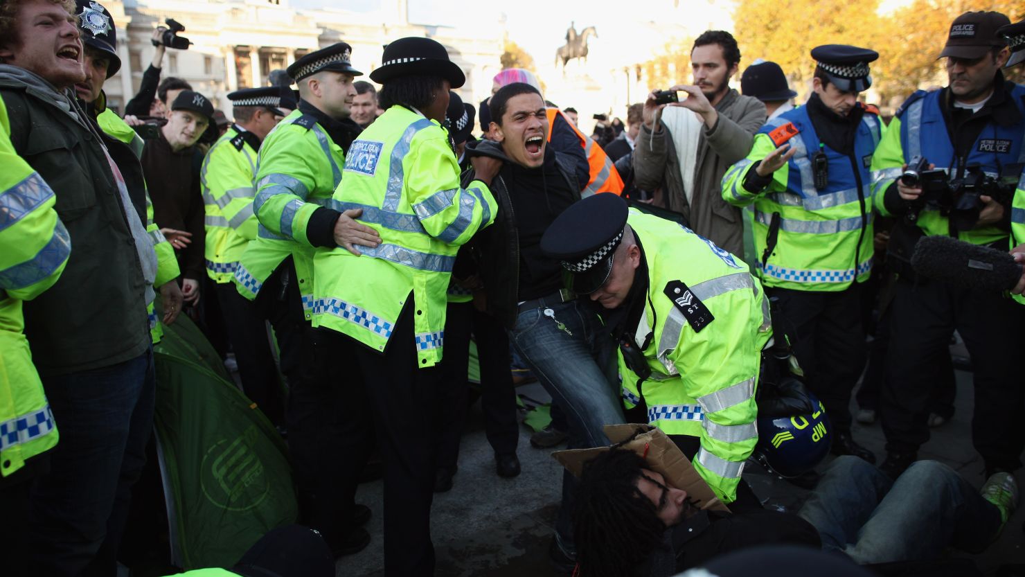 Police clear protesters as students in London take part in a demonstration against higher tuition fees.