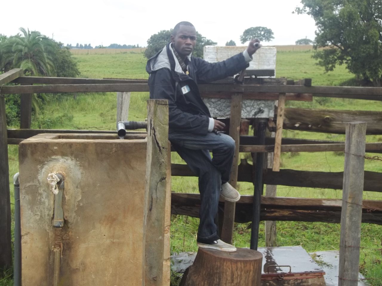 Kenyan entrepreneur Joe Mwali poses beside the borehole he created to provide water for his local community.